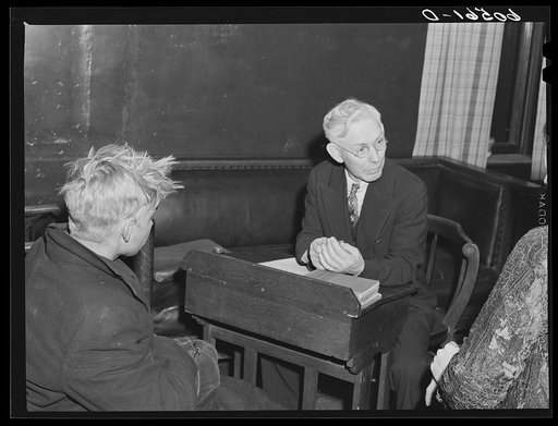 Untitled photo, possibly related to: Young boy waiting to see if he can get a place to sleep for the night. City mission, Dubuque, Iowa