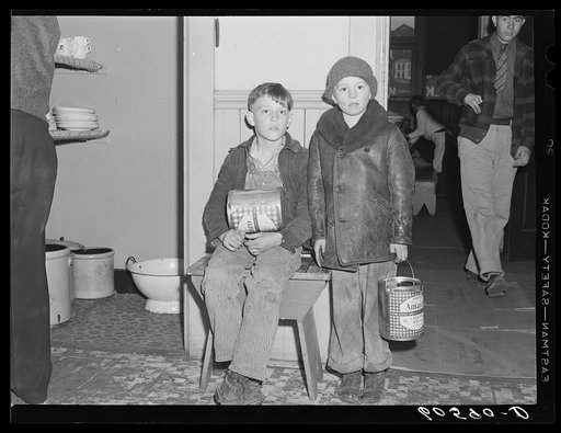 Young boys waiting in kitchen of city mission for soup which is given out nightly. Dubuque, Iowa