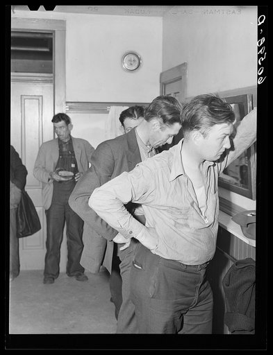 Untitled photo, possibly related to: Transient men waiting to have their clothes fumigated and take showers. City mission, Dubuque, Iowa
