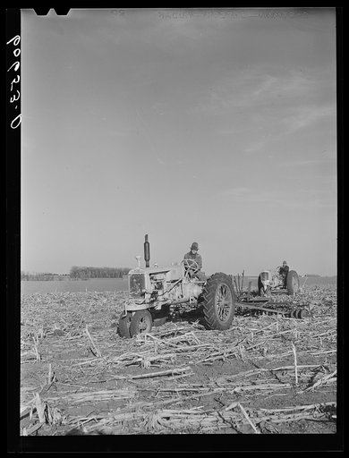 Father and son preparing a piece of land for corn planting. Grundy County, Iowa