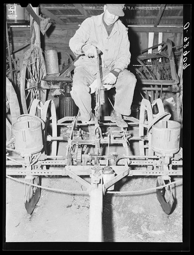 Untitled photo, possibly related to: Filling box on two-row corn planter. Grundy County, Iowa