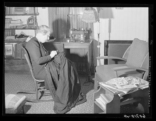Untitled photo, possibly related to: Wife of Iowa corn farmer sewing choir robes for Methodist church. Greene County, Iowa