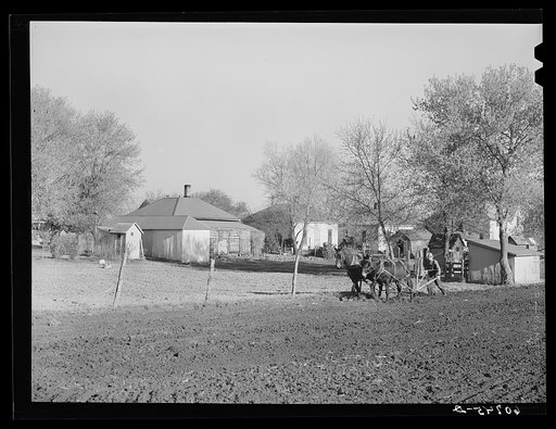 Plowing fields behind residental section. Woodbine, Iowa