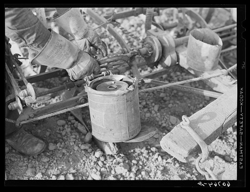 Adjusting plate on corn planter. Monona County, Iowa