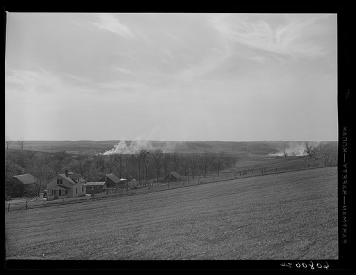 Western Iowa farmland cornstalks burning. Monona County, Iowa