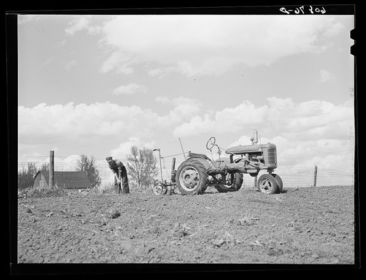 Adjusting the wire, two-row tractor corn planter. Jasper County, Iowa