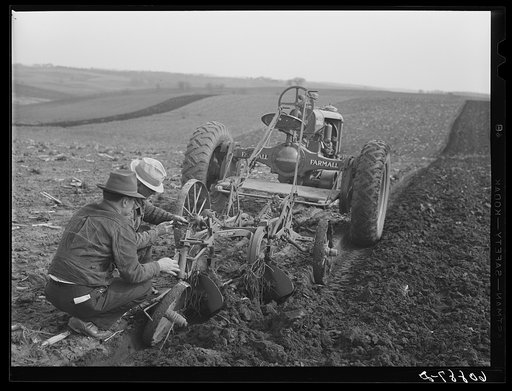 County agent helping farmer adjust plow. Jasper County, Iowa