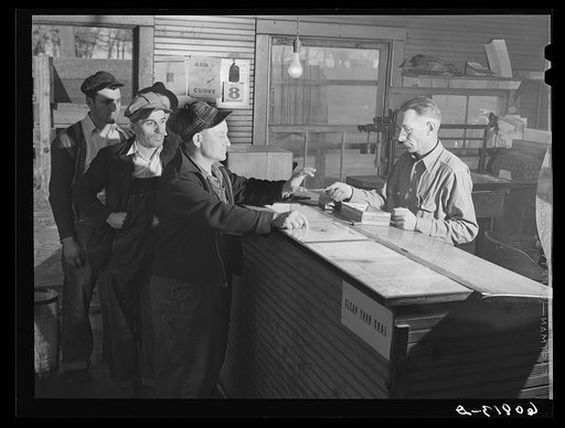 Granger Homesteaders receiving paycheck at coal mine office. Iowa