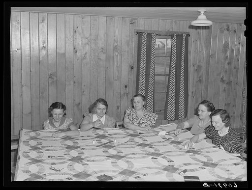 Members of the women's club making quilt. Granger Homesteads, Iowa