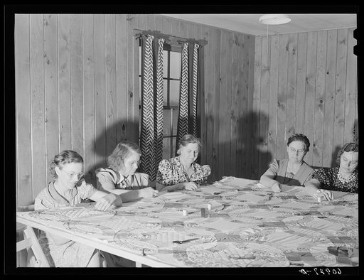 Members of the women's club making a quilt. Granger Homesteads, Iowa