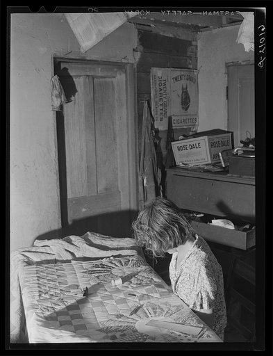 Wife of FSA (Farm Security Administration) rehabilitation borrower sewing a quilt. Grant County, Illinois