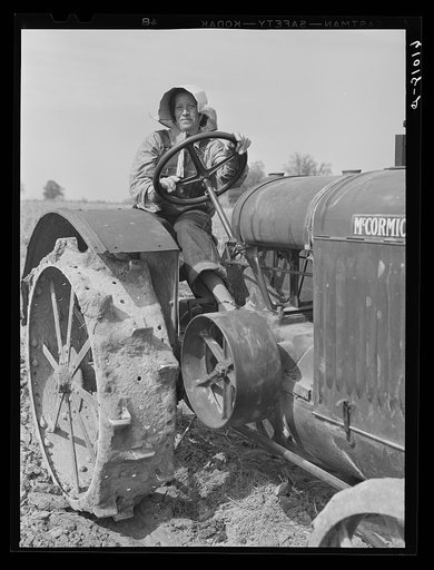Untitled photo, possibly related to: FSA (Farm Security Administration) rehabilitation borrower operating tractor. She and her mother run the farm without the assistance of any men. Grant County, Illinois