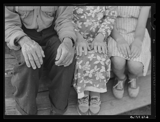 Hands of old couple and their granddaughter. Hilly Ozark farm country. Missouri