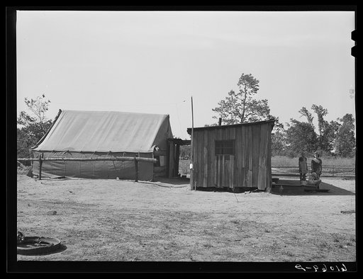 Shack and tent occupied by family on poor farmland along the riverbottoms. New Madrid County, Missouri. This family will move to one of the new Delmo labor homes
