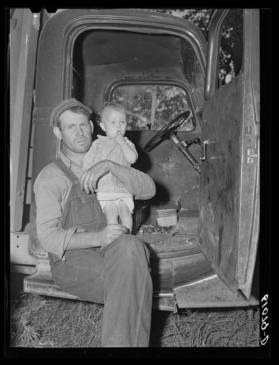 Migrant fruit worker and child camped with fifteen other families along roadside in Berrien County, Michigan