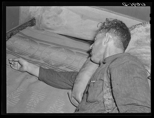 Migrant fruit worker. He has a toothache, and is using an ice-pack made of old inner-tube. Berrien County, Michigan