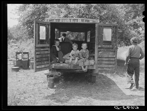 Rear of truck occupied by three children of migrant family from Arkansas. The parents sleep in a small tent. Berrien County, Michigan