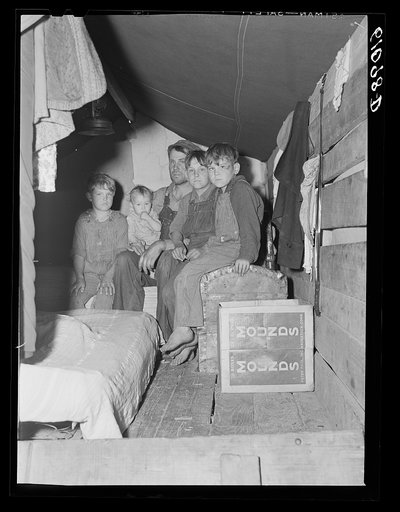 Migrant fruit worker and sons living in rear of truck during cherry picking season. Berrien County, Michigan