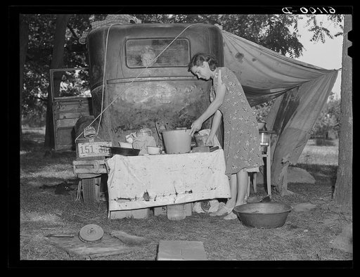 Fifteen families are camped along the roadside during cherry picking season. Berrien County, Michigan. There is one pump for these families
