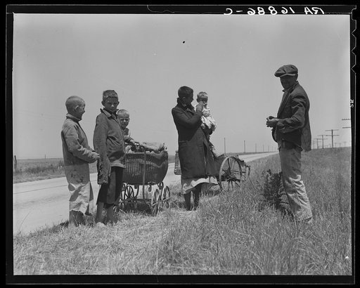 Migrant fruit workers from Louisiana fixing flat tire along the road. Berrien County, Michigan