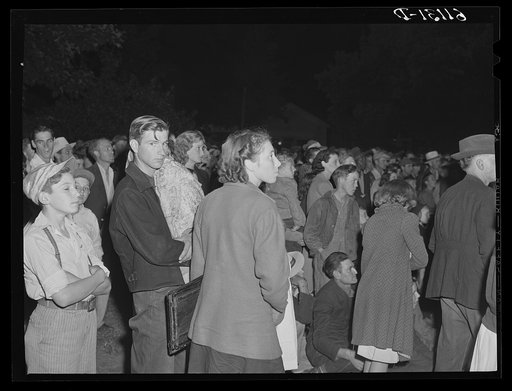 Untitled photo, possibly related to: Migrant fruit workers come to town on Saturday night for a free open air movie sponsored by the local merchants who remain open for business. Millburg, Michigan