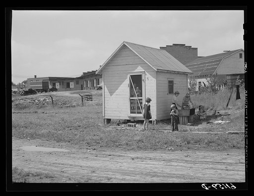 One of the nine cabins adjoining fruit packing plant. Families of seven and eight sometimes live in these one dollar and seventy-five cents a week cabins. Berrien County, Michigan
