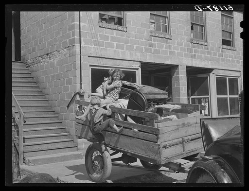 Trailer loaded with furniture of family about to move on in search of work picking fruit. Berrien County, Michigan