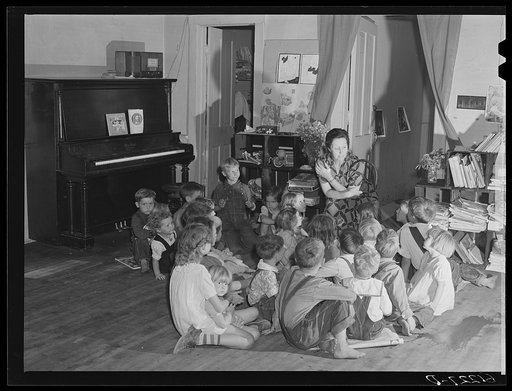 Teacher telling story to migrant children in nursery school run by Women's Council for Home Missions. Berrien County, Michigan
