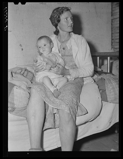 Untitled photo, possibly related to: Mother of five children preparing evening meal. They live in an abandoned house on property of fruit grower. Berrien County, Michigan