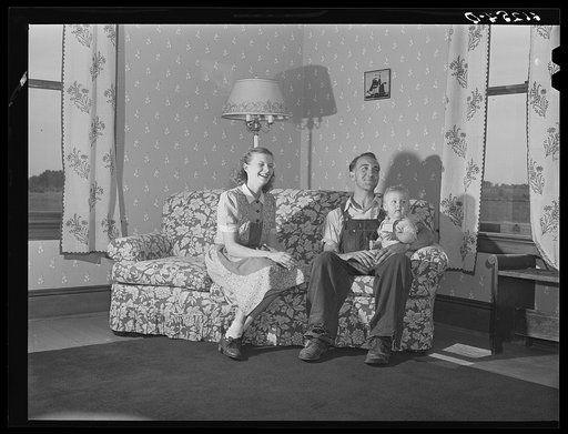 FSA (Farm Security Administration) rehabilitation borrower and family. The wife made the drapes, the chair covers, and papered the wall herself. Door County, Wisconsin