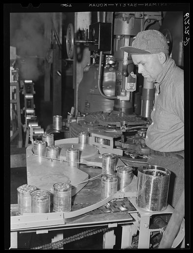 Operating machine which seals cans of cherries. Canning plant, Sturgeon Bay, Wisconsin