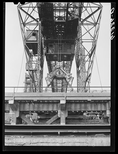 Unloading iron ore from freight cars. Bethlehem steel mill. Sparrows Point, Maryland