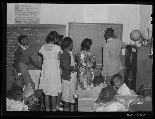 Teacher explaining decimals to seventh grade students. One-room schoolhouse, Saint Mary's County, Maryland