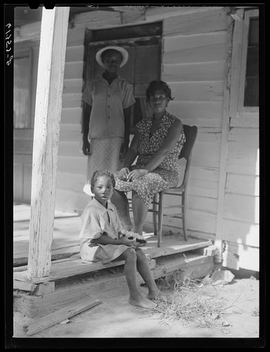 Untitled photo, possibly related to: Mrs. Calip White and two of her children on front porch of their home near Scotland, Saint Mary's County, Maryland