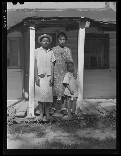 Untitled photo, possibly related to: Mrs. Calip White and two of her children on front porch of their home near Scotland, Saint Mary's County, Maryland
