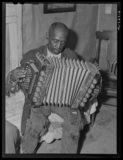 John Dyson, FSA (Farm Security Administration) borrower, playing the accordion. He was born into slavery over eighty years ago. Saint Mary's County, Maryland