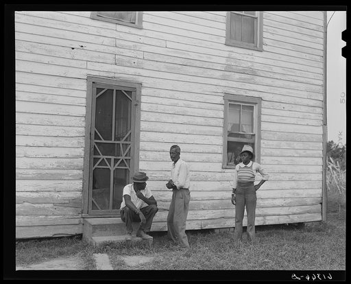 John Barnes with his sons in front of their house. He is a FSA (Farm Security Administration)  rehabilitation borrower. Saint Mary's County, Maryland