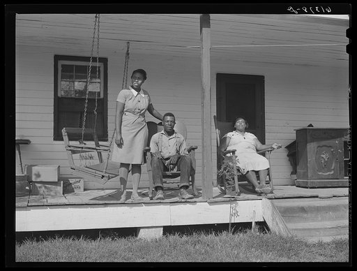 Harry Handy, FSA (Farm Security Administration) borrower, with wife and daughter on front porch of their home. Saint Mary's County, Maryland