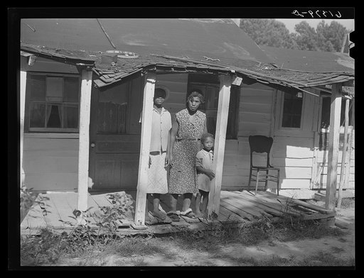 Mrs. Calip White and two of her children on front porch of their home near Scotland, Saint Mary's County, Maryland
