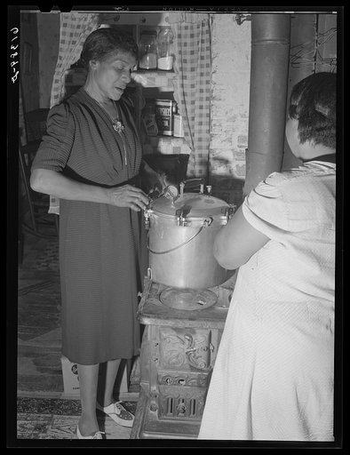 Miss Chappelle, FSA (Farm Security Administration) home supervisor, instructing Mrs. Handy, FSA borrower, in use of pressure cooker. Saint Mary's County, Maryland