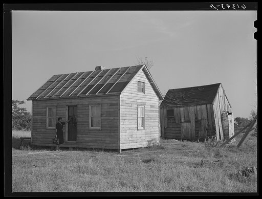 Old and new house of George W. Green, FSA (Farm Security Administration) borrower. Saint Mary's County, Maryland. Magaritte Chappelle, FSA home supervisor, knocking on the door