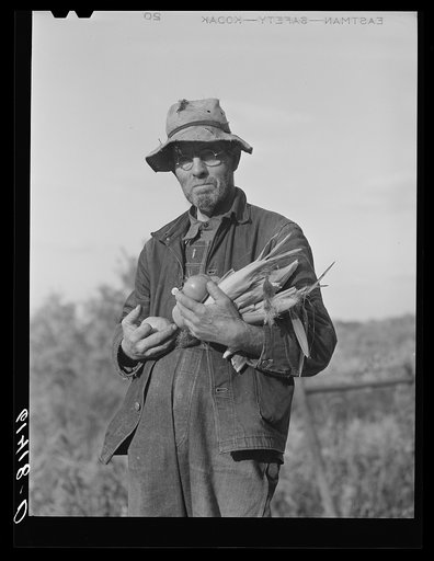 Hill farmer with armful of vegetables from his garden patch. Ross County, Ohio