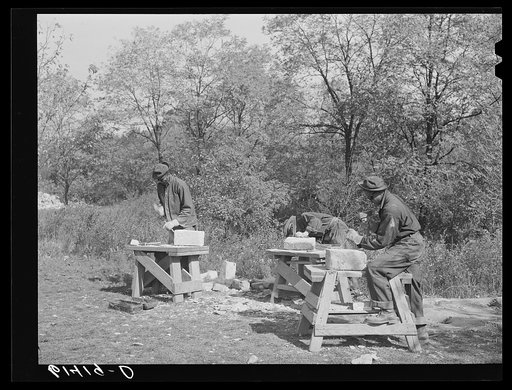 CCC (Civilian Conservation Corps) boys chopping stones for use in building charcoal burners at picnic grounds of recreation area. Ross County, Ohio