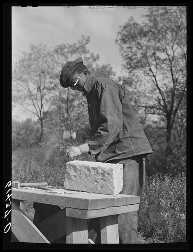 CCC (Civilian Conservation Corps) boy chopping stone for use in building charcoal burners at picnic grounds. Ross County, Ohio, recreation area