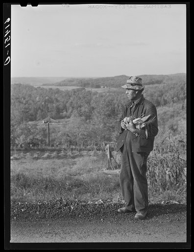 Hill farmer with an armful of vegetables from his garden patch. Ross County, Ohio