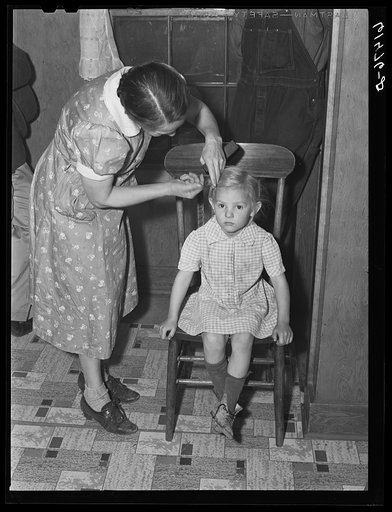 Mrs. Amundson combing child's hair. Red River Valley Farms, North Dakota