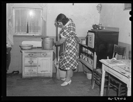 Mrs. Sauer sweeping kitchen floor. Cavalier County, North Dakota