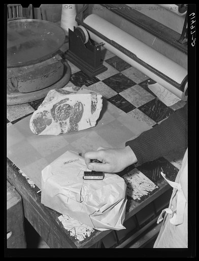 Stamping cut of meat before removing to freezing room. Cold storage locker, Casselton, North Dakota