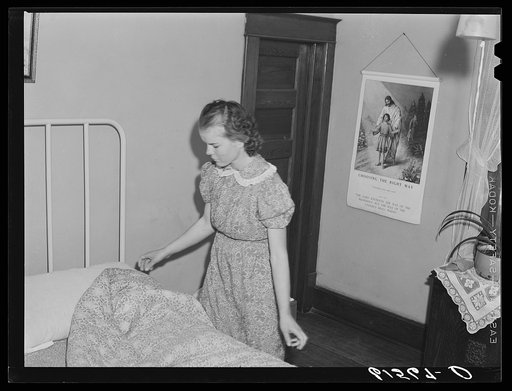 Farm girl making bed. McIntosh County, North Dakota