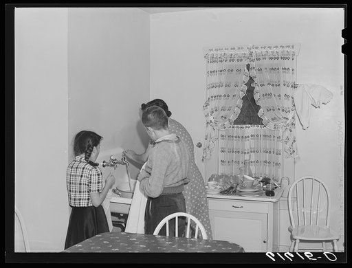 Untitled photo, possibly related to: One of the Schulstead children reading funny papers. Aberdeen, South Dakota